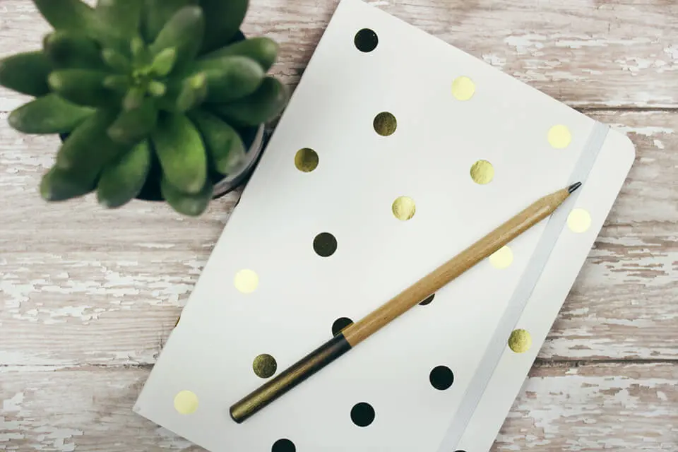 Journal with pencil sitting on table