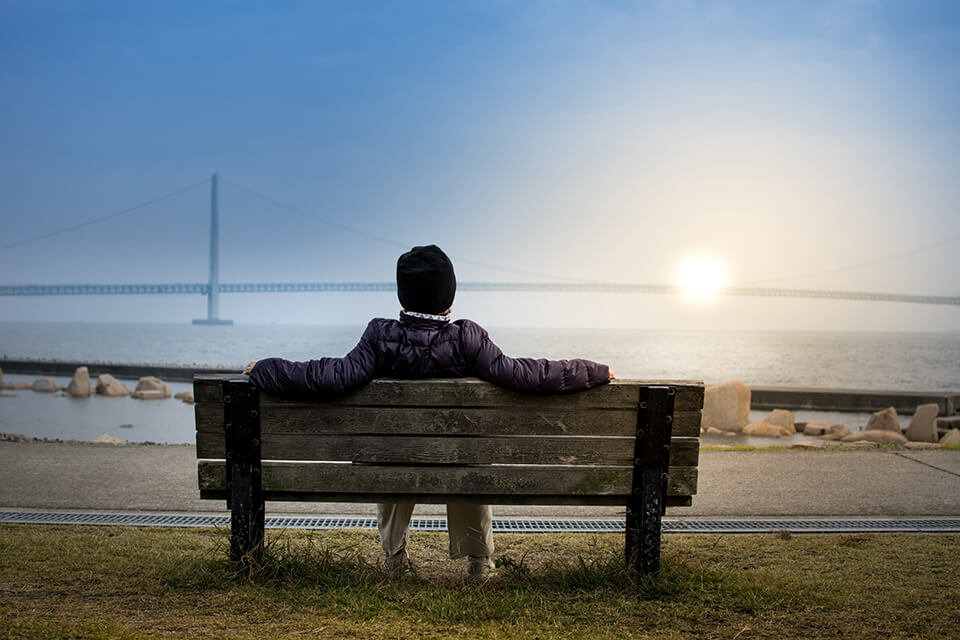 Man sitting on bench in park, relaxing