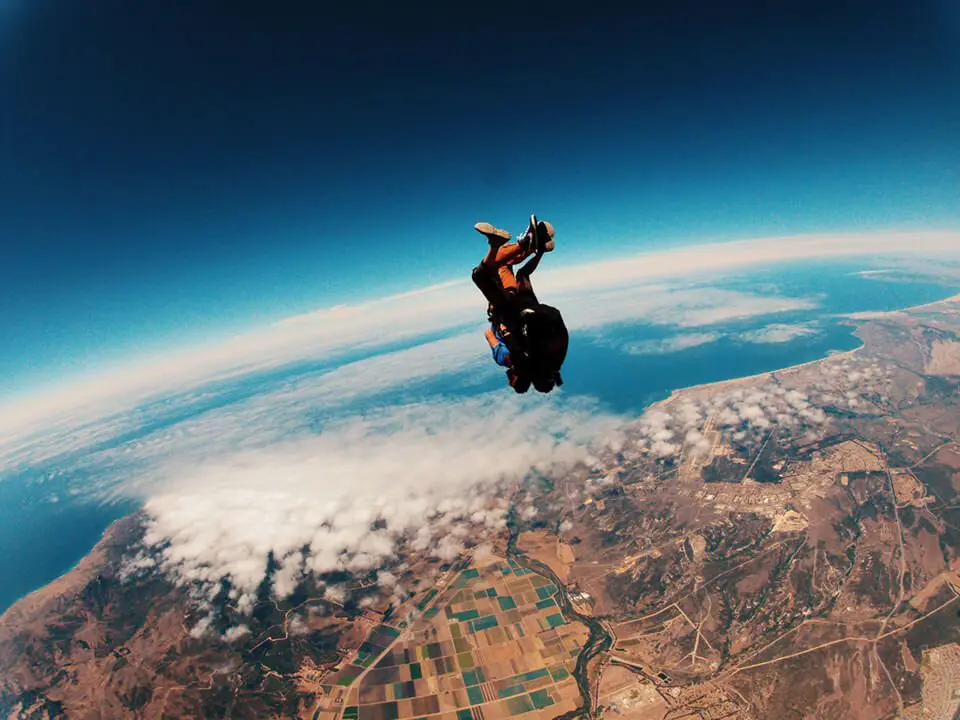 Man tandem jumping out of plane, skydiving