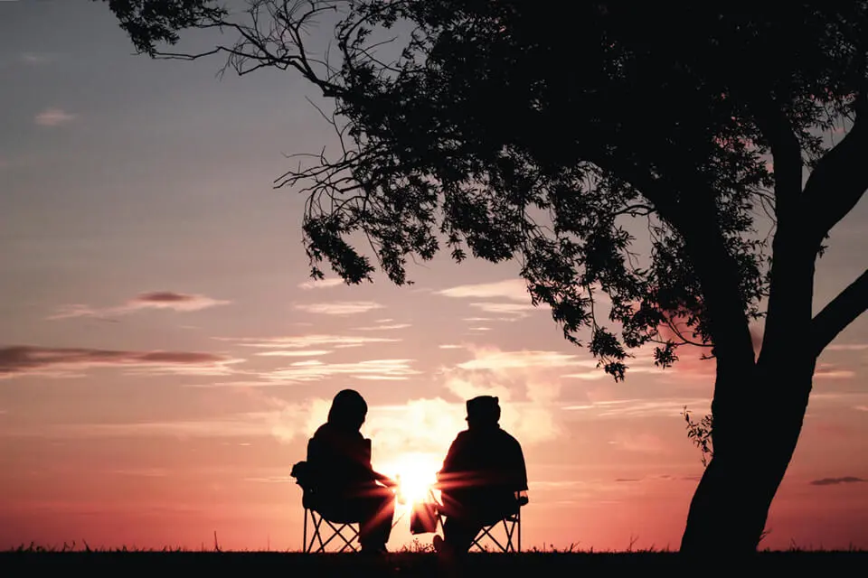 Two friends overlooking a sunset