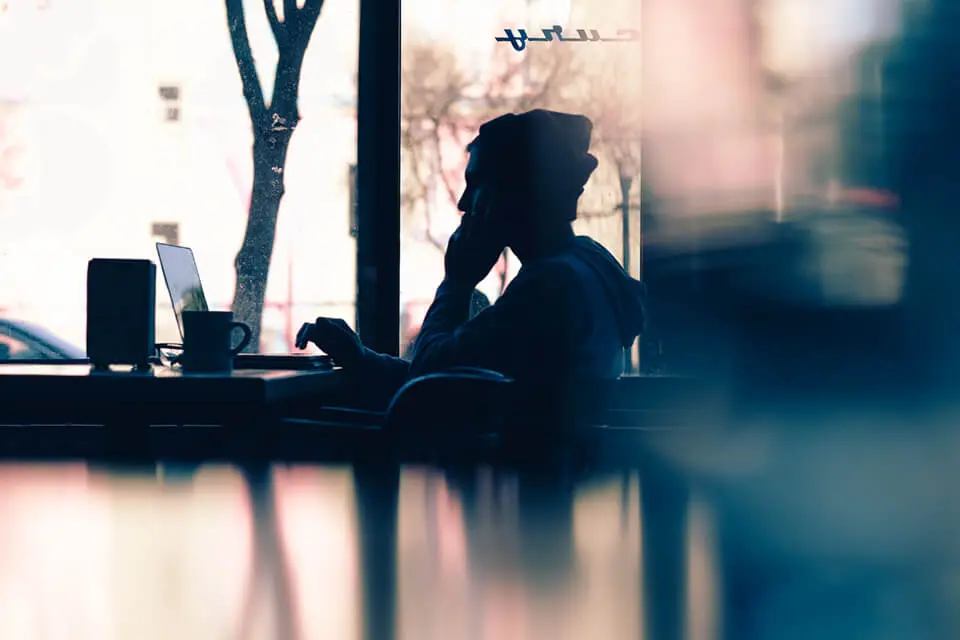 Man on cell phone in coffee shop