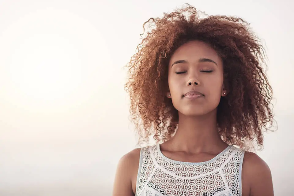 Woman standing and practicing meditation
