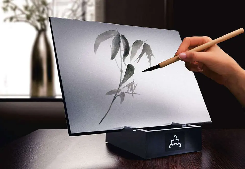 Person using Buddha Board to create a water painting