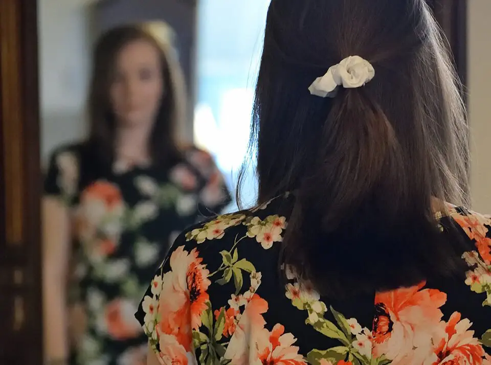 Woman staring at her self in the mirror