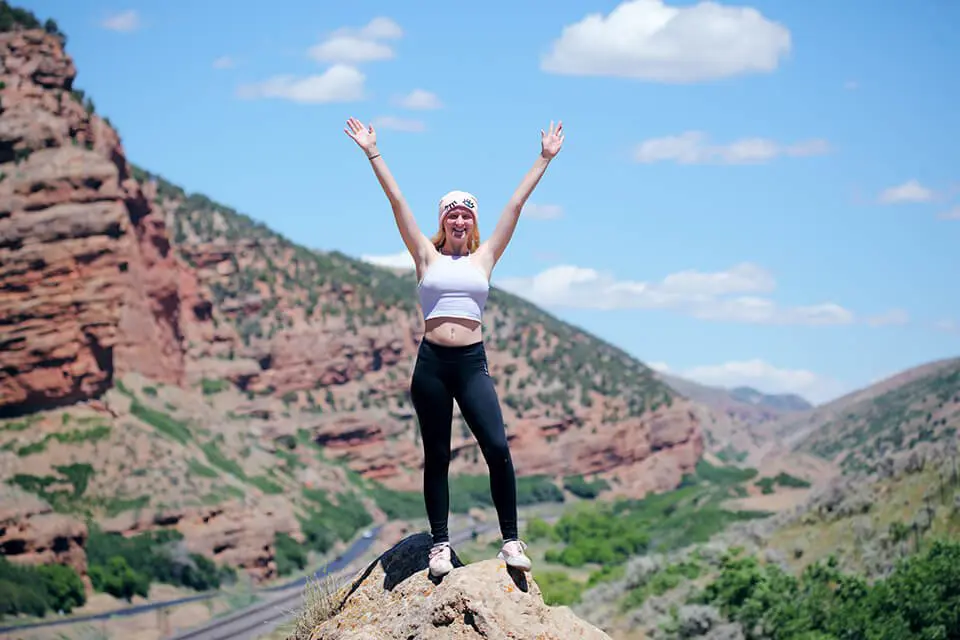 Woman on top of hill, celebrating her courage