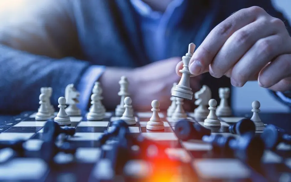 a man is playing a game of chess.