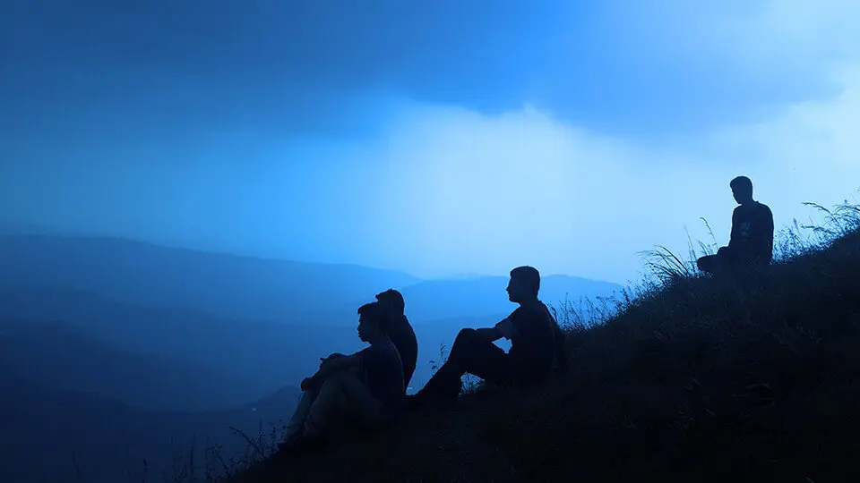 Group of friends in meditation on a hill