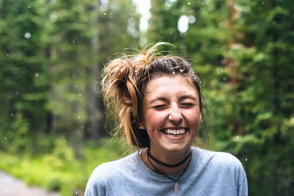 Woman laughing and smiling outside