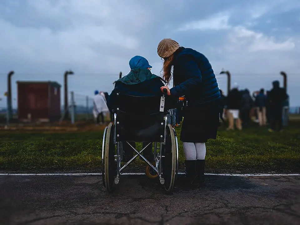 Woman helping a man in a wheelchair