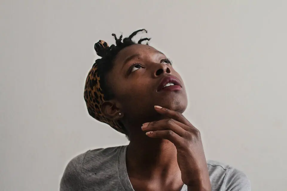 Woman with head tilted back lost in thought
