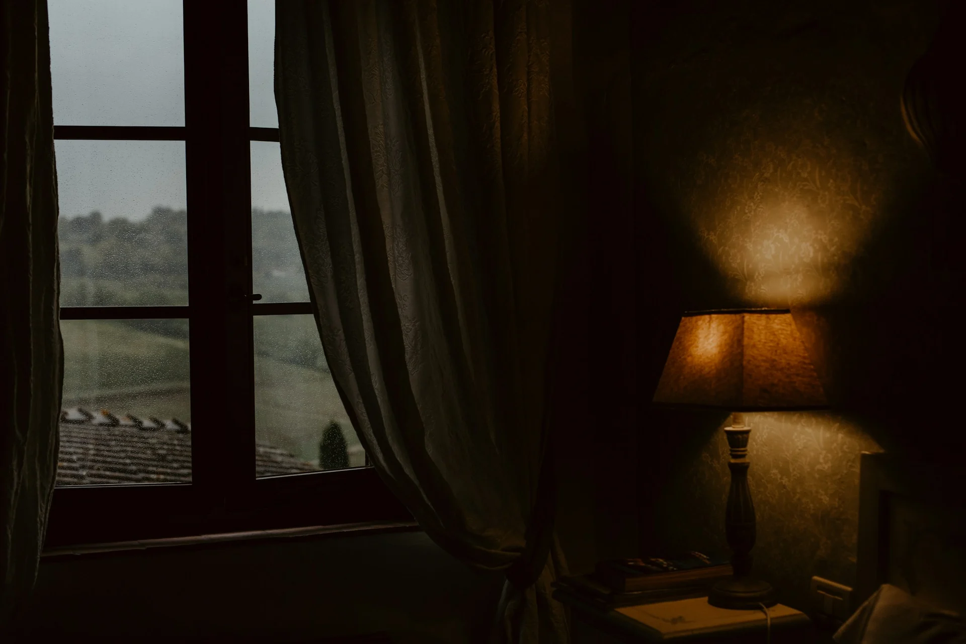 Soft evening light through a window over a quiet interior, evoking waiting and longing