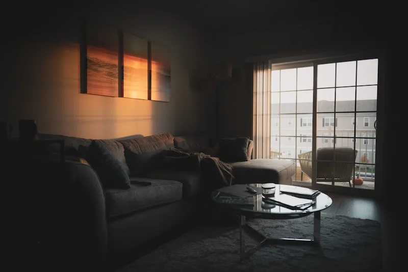 A quiet living room in soft, warm evening light