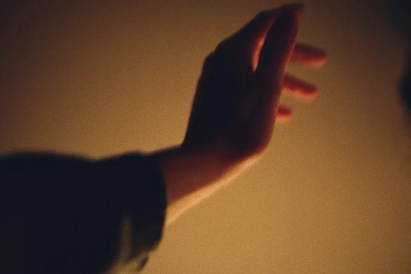 A relaxed open hand resting in soft, warm light.