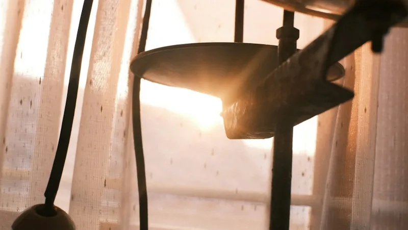 Warm golden light filtering through a sheer curtain in a calm room