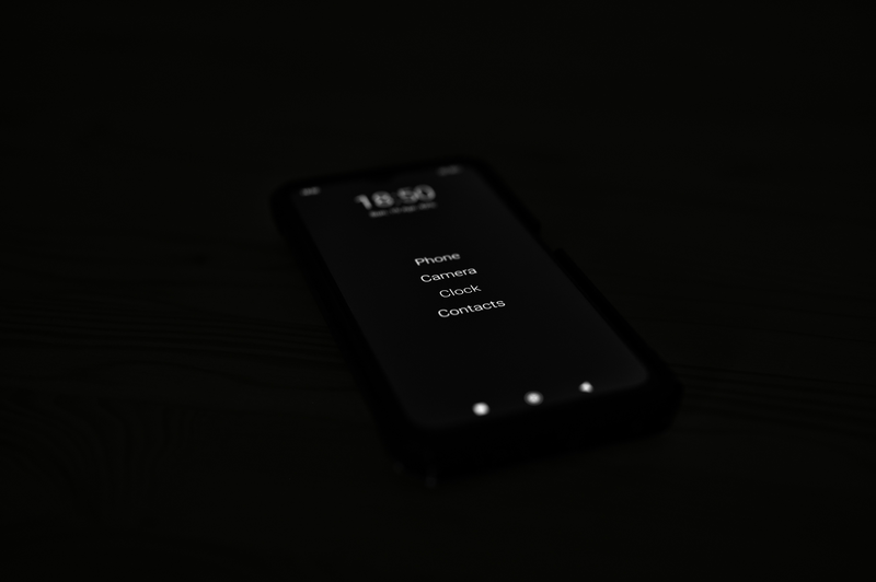 A smartphone screen glowing in the dark.