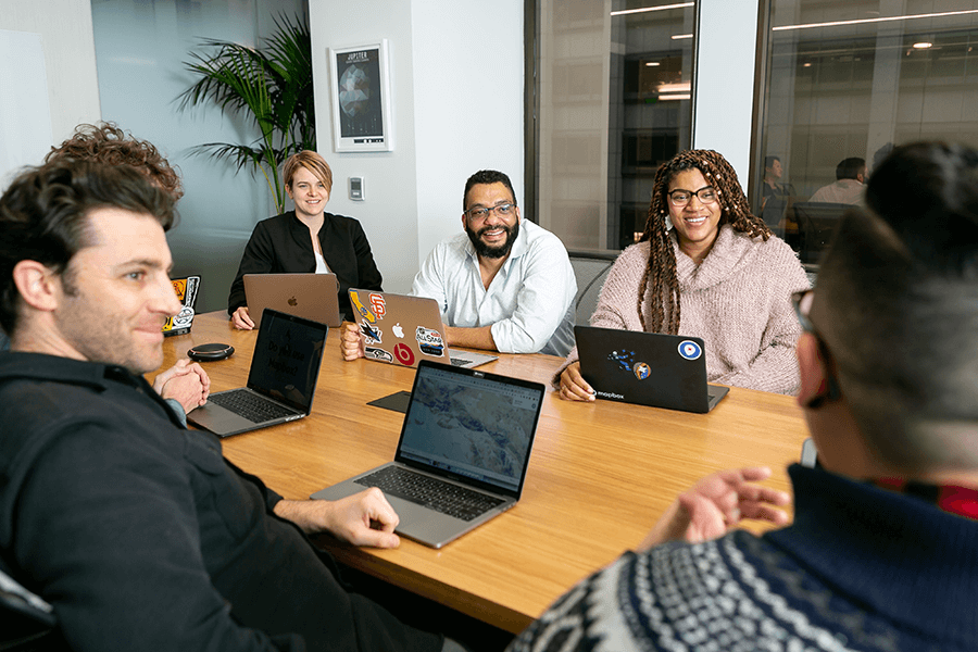 employees sitting around conference table