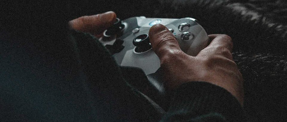 Close up of hands holding a game controller