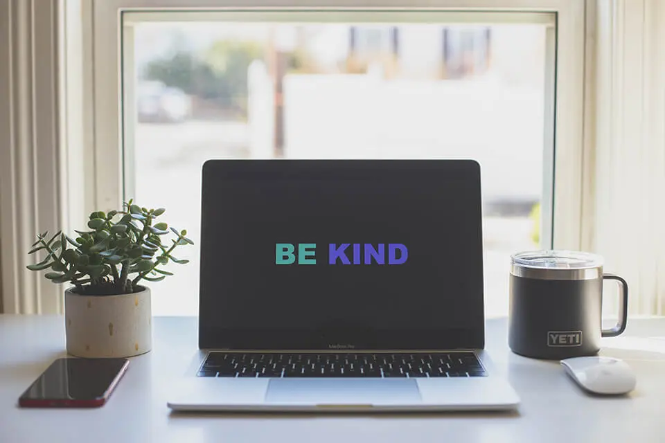 Laptop computer with the words "be kind"