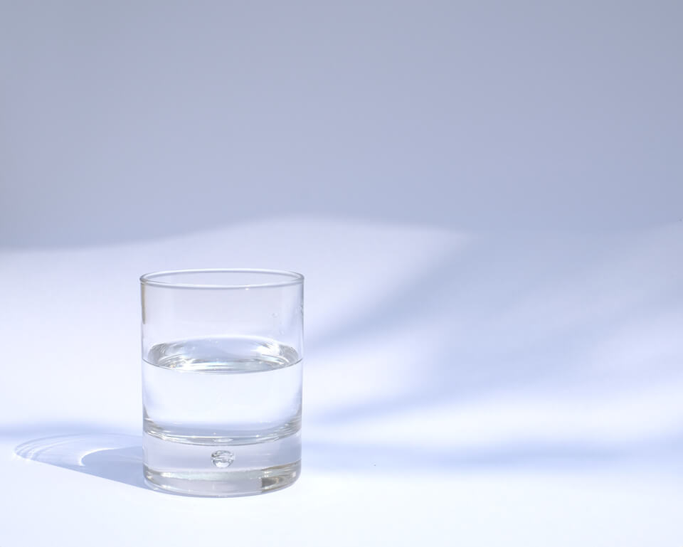 Glass of water sitting in an open space