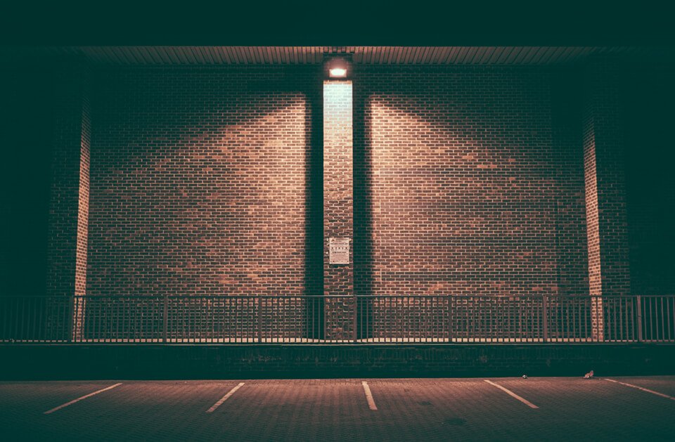 A brick wall, dimly lit at night