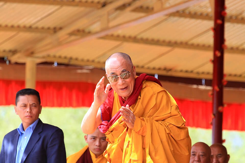 Dalai Lama waving at crowd