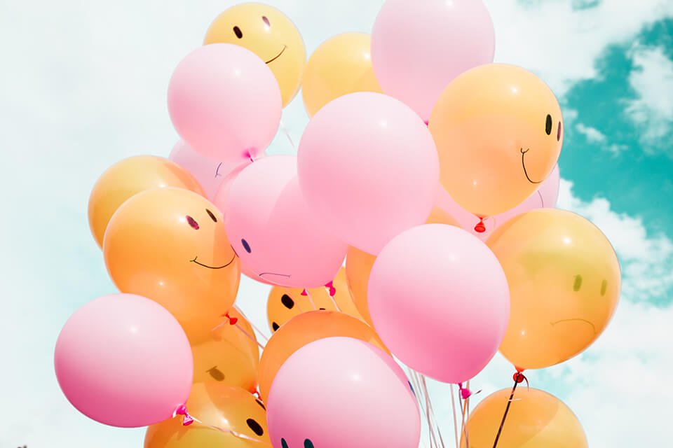 Balloons with smiley and frown faces on them