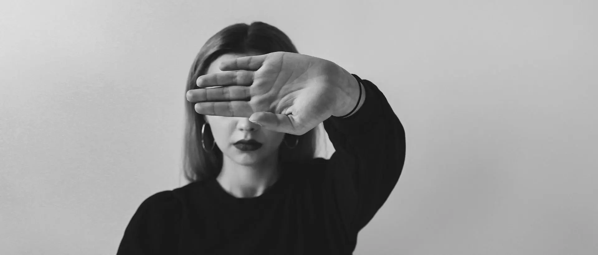 a woman covering her eyes with her hands.