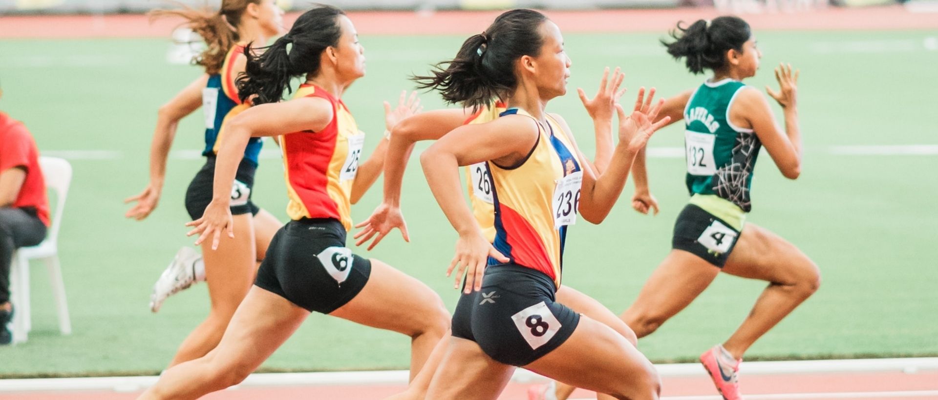 a group of women running on a track.