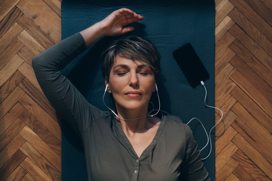 a woman listening to music with headphones on.