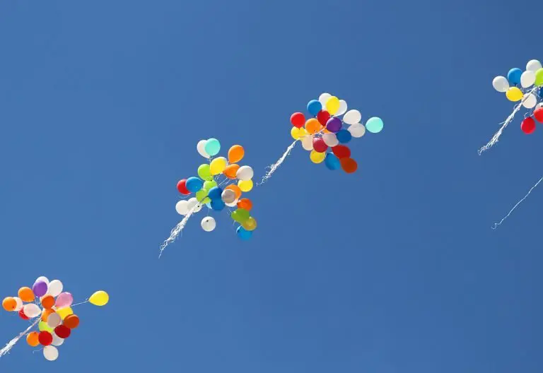 a group of balloons flying in the sky.