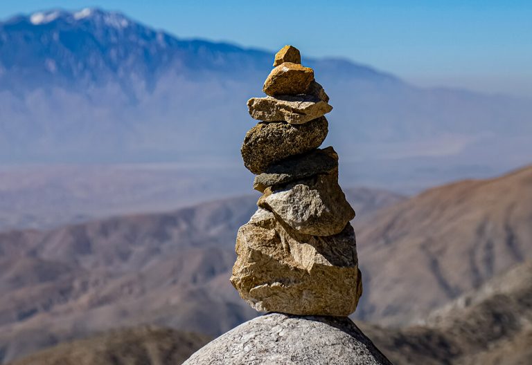 a stack of rocks sitting on top of a mountain.