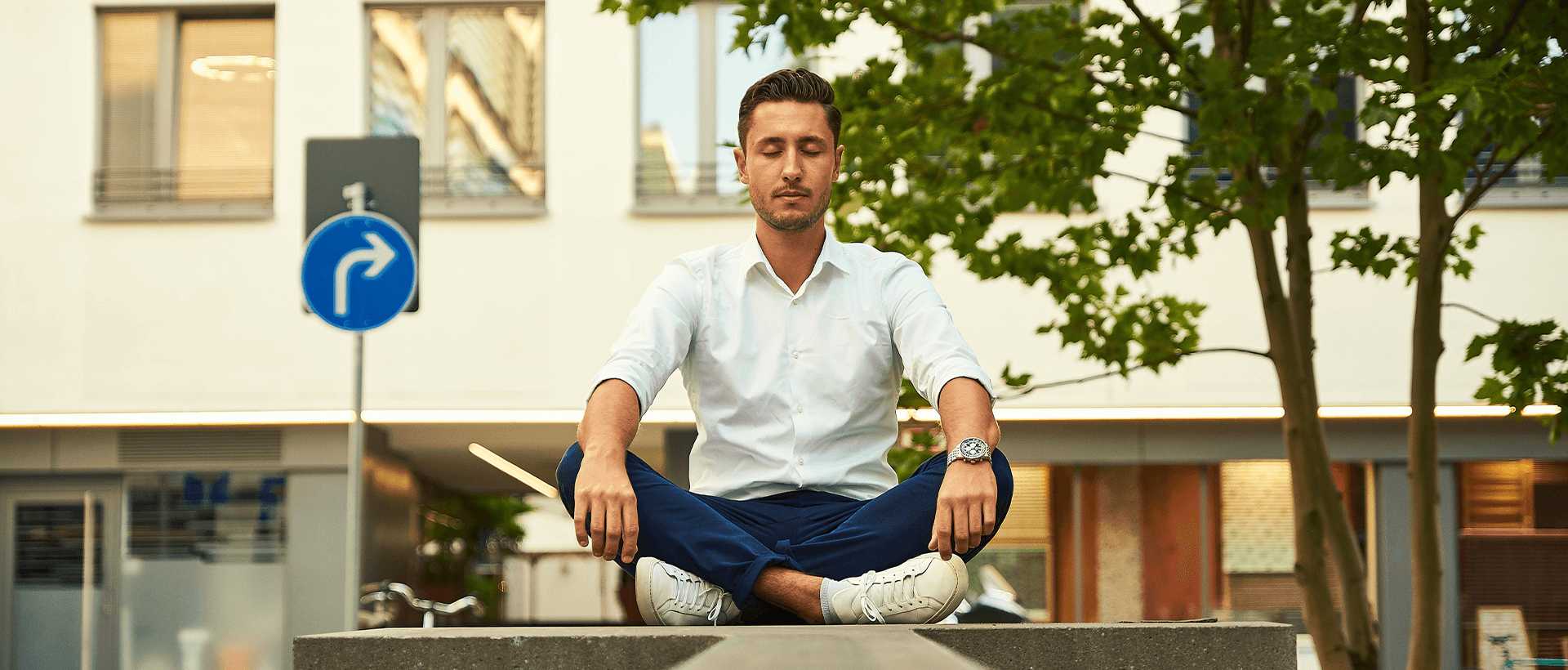 a man in white shirt and blue pants doing yoga.