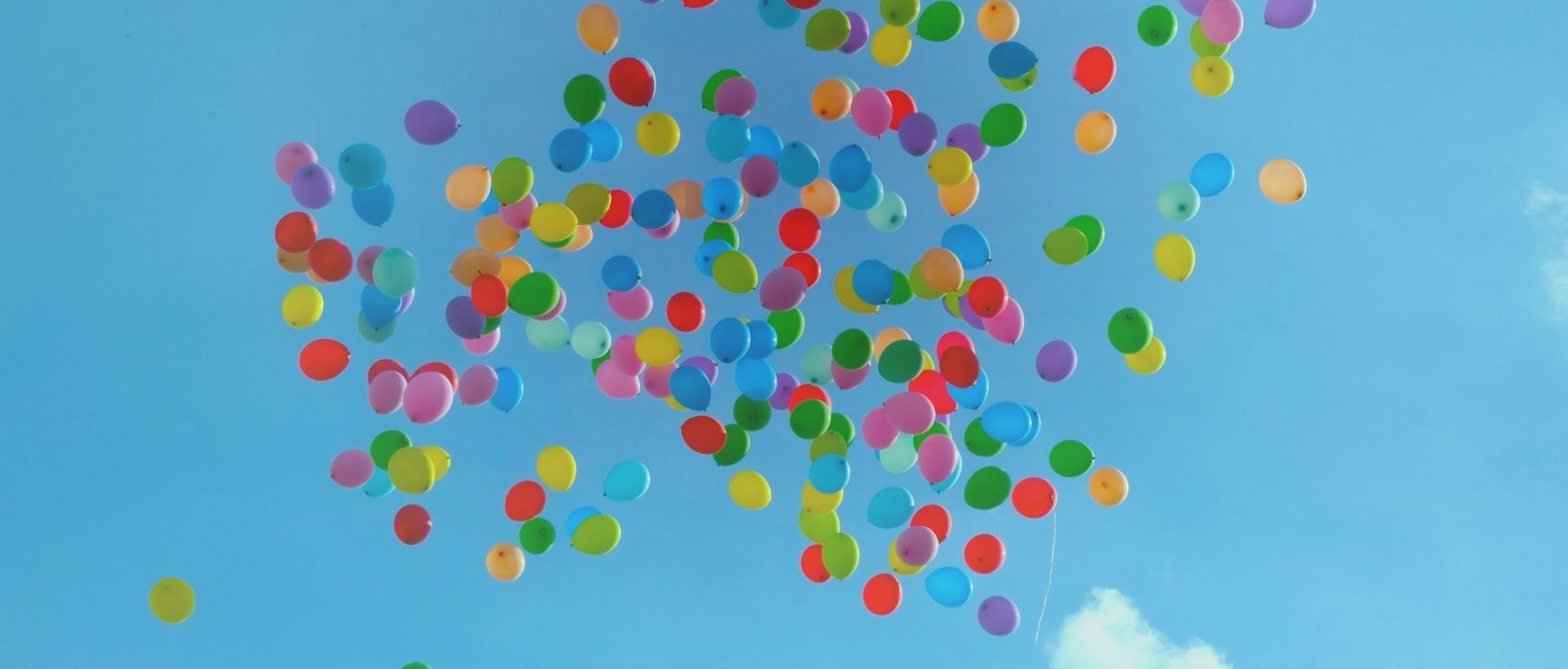 a bunch of balloons floating in the air.