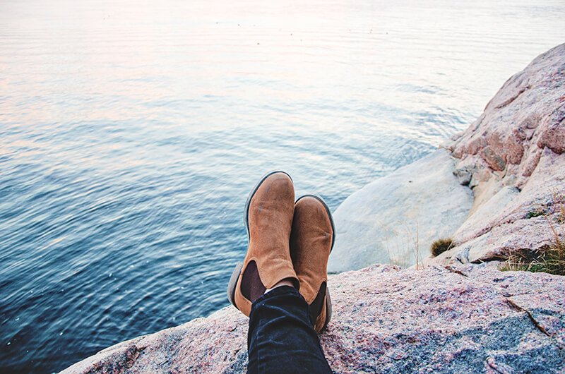 Feet crossed, relaxing overlooking a lake