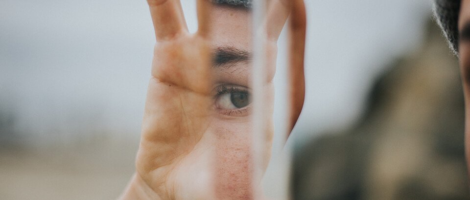 a close up of a person's hand with a blurry image of a.