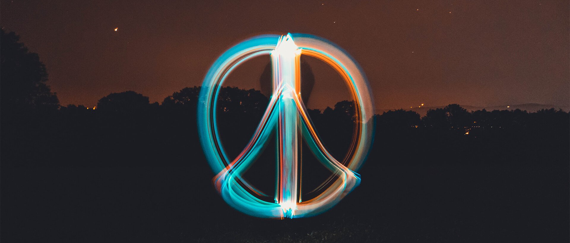 a long exposure photo of a peace sign.