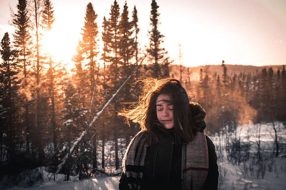 Woman lost in thought in a snowy wilderness