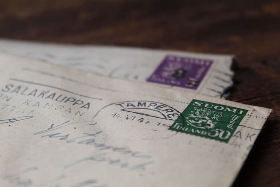 Closeup of two stamped cards in envelopes